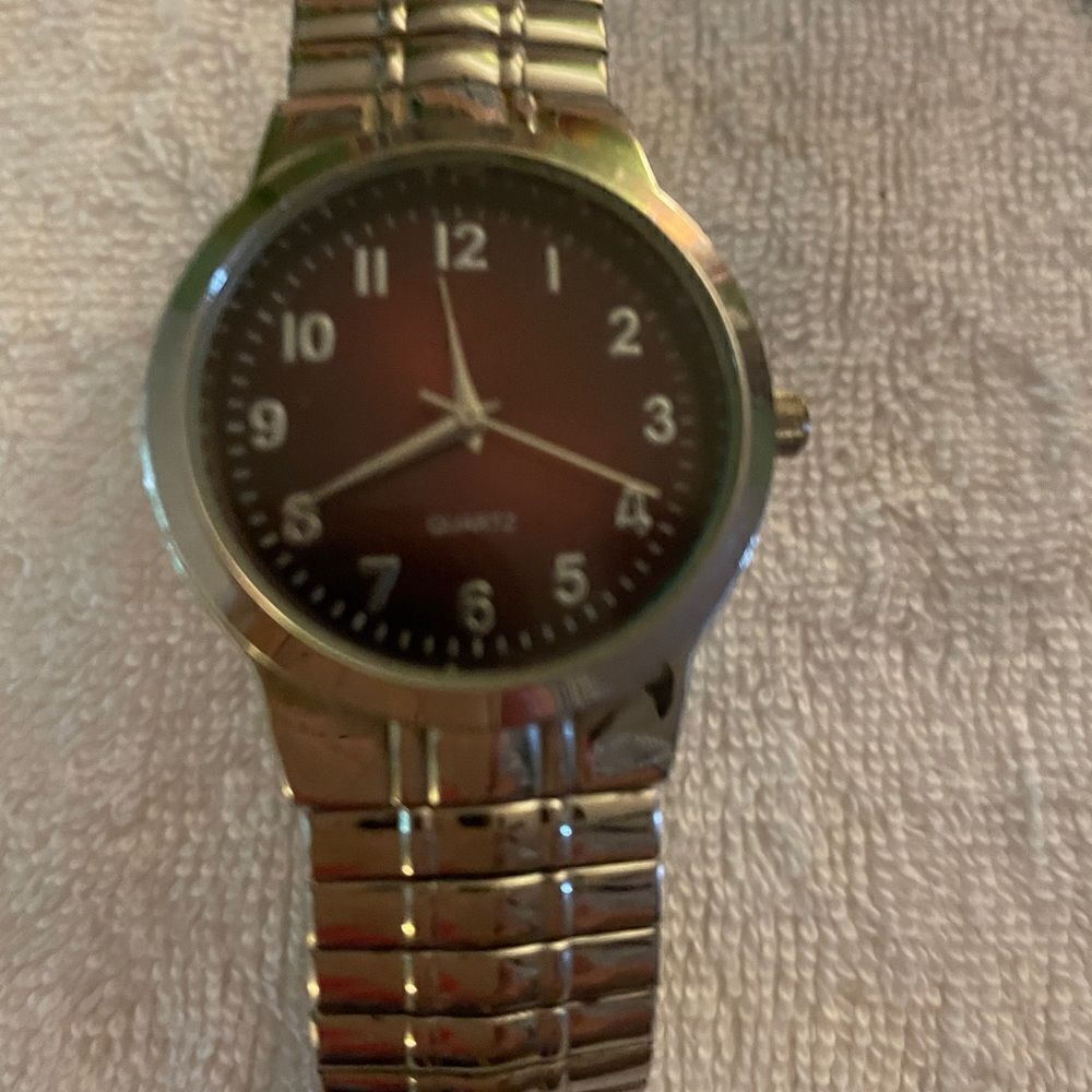 Men’s Fashion watch with brown face. Stretch silver band.